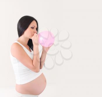 pregnant woman with pink balloon