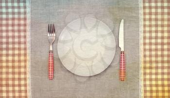 Empty plate with fork and knife.Vintage retro style. Paper textured.