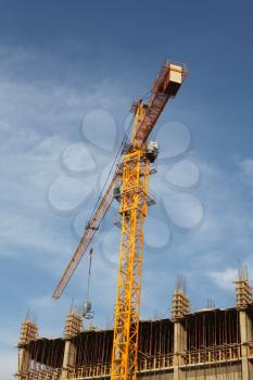 Crane and building house under blue sky