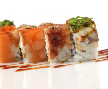 Sushi rolls with salmon, eel fish, wakame seaweed on white