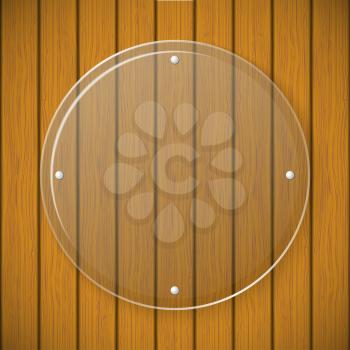 Round glass plate on the background of wooden wall 