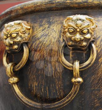 Closeup ancient bronze lions as a handle of vat in Forbidden City