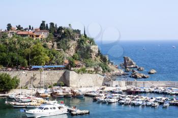 Famous old harbor in Antalya with boats, ships and yachts anchored in it.