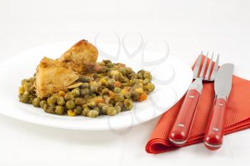 Baked chicken meat with green peas, carrots and corns