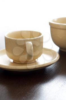 Empty brown ceramic coffee cup and bowl