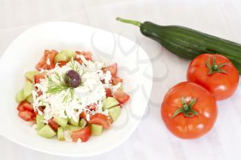 Fresh Mediterranean salad with tomatoes, cucumber, onion, feta cheese and olive.