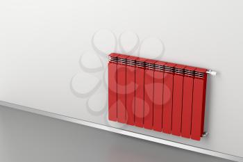 Red heating radiator attached on grey wall