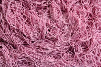 Background of tangled pink thread texture of thick threads