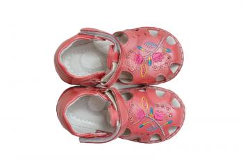Beautiful pink baby shoes on a white background, isolated