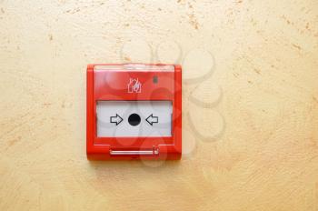 Fire alarm button installed on the wall in the room.