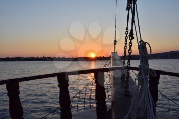 Silhouette of the ship's mast against the evening sky and sunset in the city of Gelendzhik