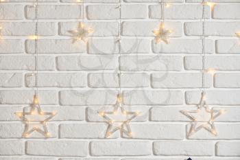 White brick wall and star-shaped garland.