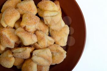 Fresh crispy cottage cheese cookies lies on a brown plate
