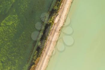 The lake with a path in the middle. Photo in Qinghai, China.