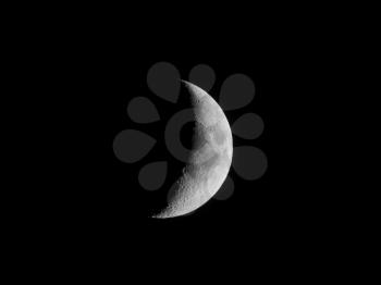 Waxing crescent moon seen with an astronomical telescope in black and white