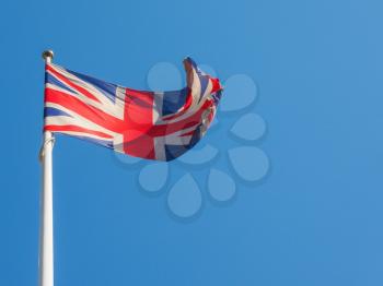 The national flag of United Kingdom, Europe floating in the wind over blue sky