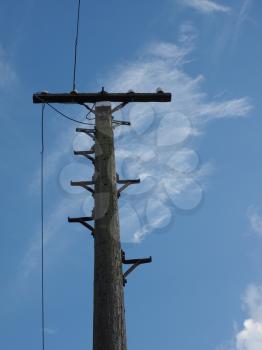 Vintage wooden telegraph pole over the blue sky