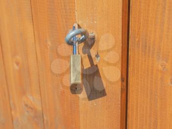 Detail of padlock on a wooden door