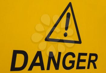 generic danger warning sign in black over yellow
