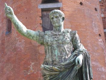 Roman statue of Caesar Augustus in front of roman walls