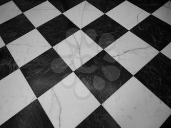 vintage black and white marble checkered floor useful as a background