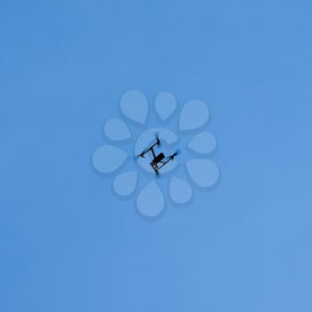 drone (unmanned aerial vehicle) hovering in the blue sky