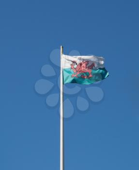 the Welsh national flag of Wales, UK over blue sky