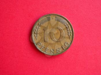Vintage 10 pfenning coin from Germany over red background