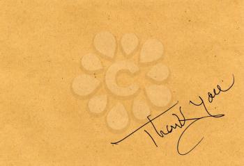 Thank you message over brown paper background with copy space