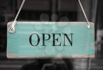 Open sign in a shop window with reflections