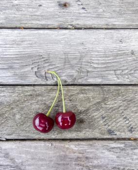 Cherries on wooden background. Red berry on board texture
