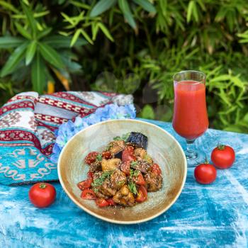 Beautiful eggplant salad with tomato, juice with green background