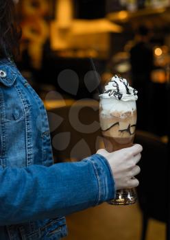 Woman holding cold chocolate milky cocktail