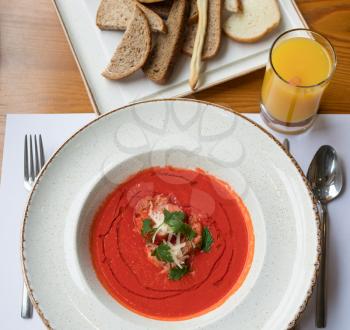 Tomato soup with orange juice and bread