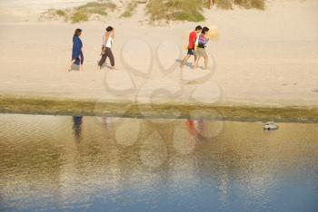 Royalty Free Photo of a Family Walking Along Water