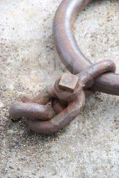 Royalty Free Photo of a Rusty Mooring Ring for Ships on Dock