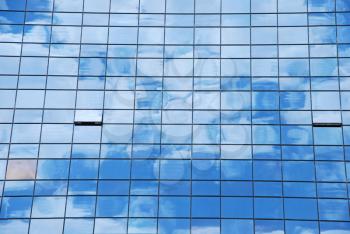 Royalty Free Photo of a Reflection of Clouds on a Building