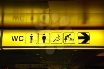 Royalty Free Photo of a Yellow Public Toilet Sign