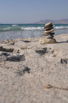 Royalty Free Clipart Image of a Pebble Stack on Kos Beach