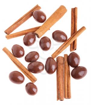 Royalty Free Photo of Chocolate Coated Almonds and Cinnamon Sticks 