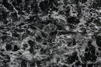 Waves in the ocean creating foam