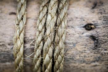 Closeup of old rustic rope tied around wood