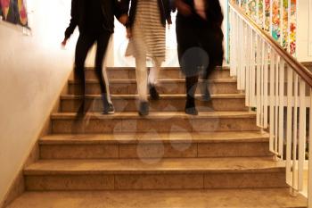 three girls walking down the stairs at school