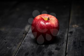 fresh red apple on a wooden table