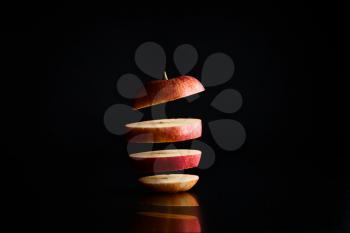fresh apple in pieces on a black background