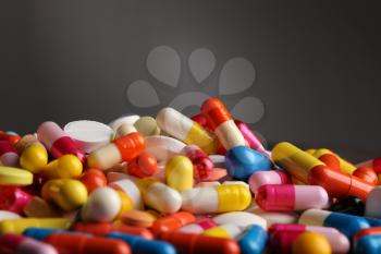 Colorful pills on grey background�