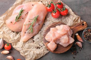 Composition with raw chicken fillet on table�