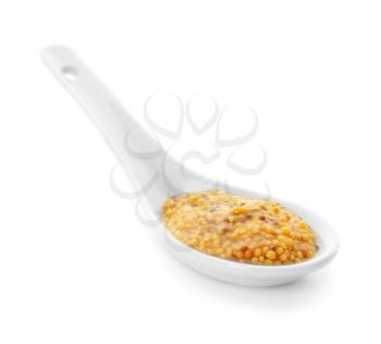 Dijon mustard in spoon on white background�