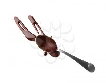 Spoon and molten chocolate on white background�
