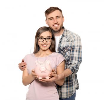 Happy couple holding piggy bank on white background. Money savings concept�